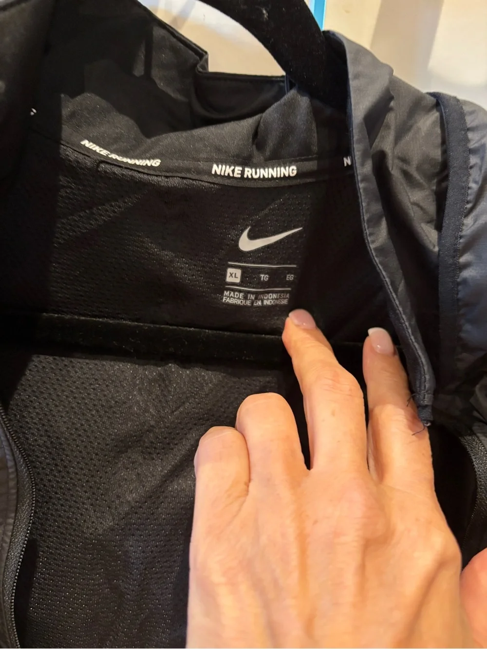 Nike Black Hooded Rain Jacket with Reflective Swoosh. Longer in back, hood.